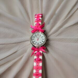 Betsey Johnson watch with a fuchsia plaid strap and crystal-accented bezel
